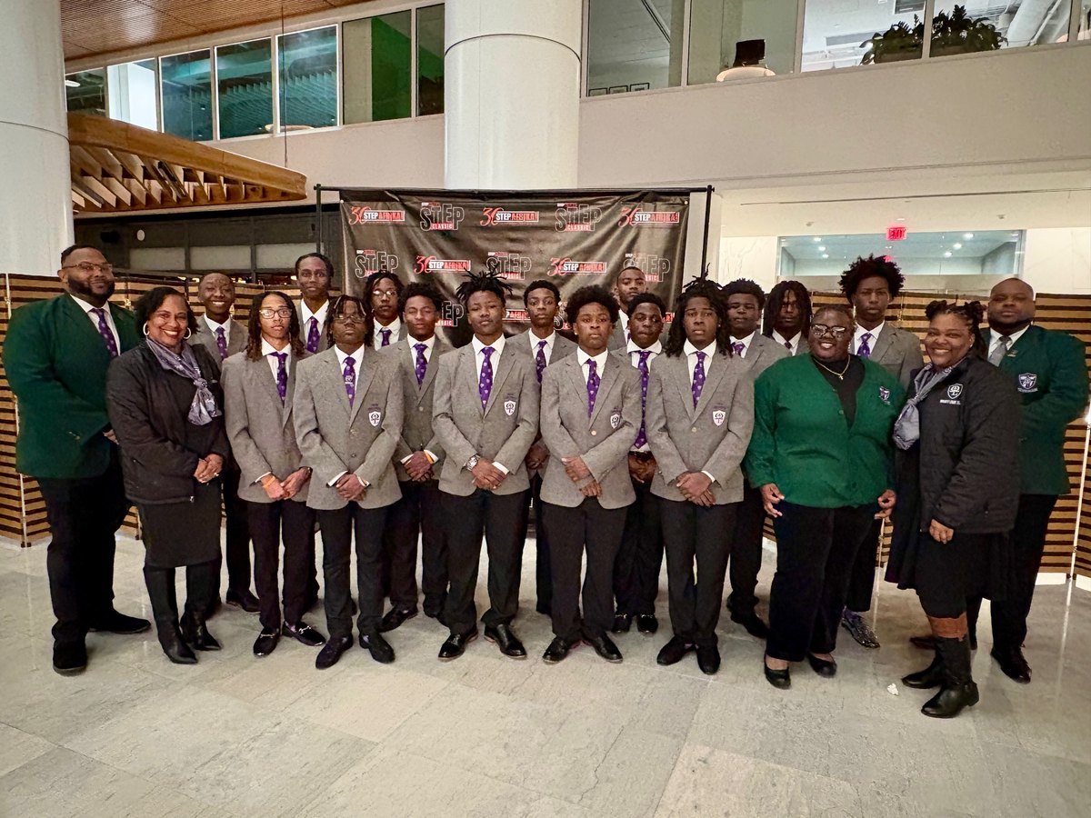 The Omega Lamplighters Mighty Light Team in matching gray blazers and purple ties at the Step Afrika! Step Classic