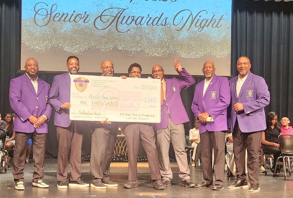 Pi Nu Nu Chapter members present a $1,000 scholarship check to Alcovy High School at Senior Awards Night, May 13, 2026